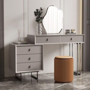 A white dressing table with a large mirror,